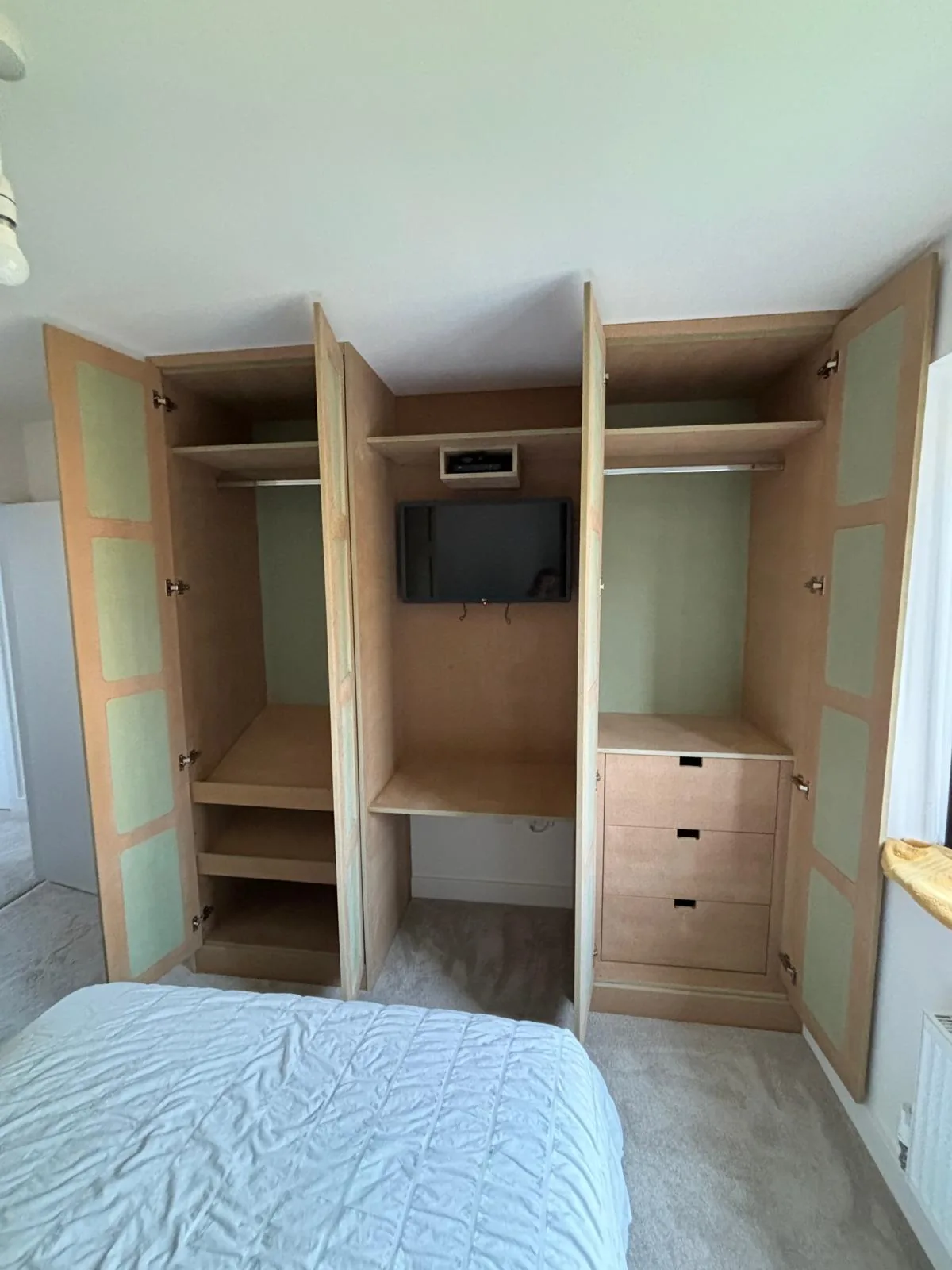 Wardrobe interiors with integrated television by RT Carpentry