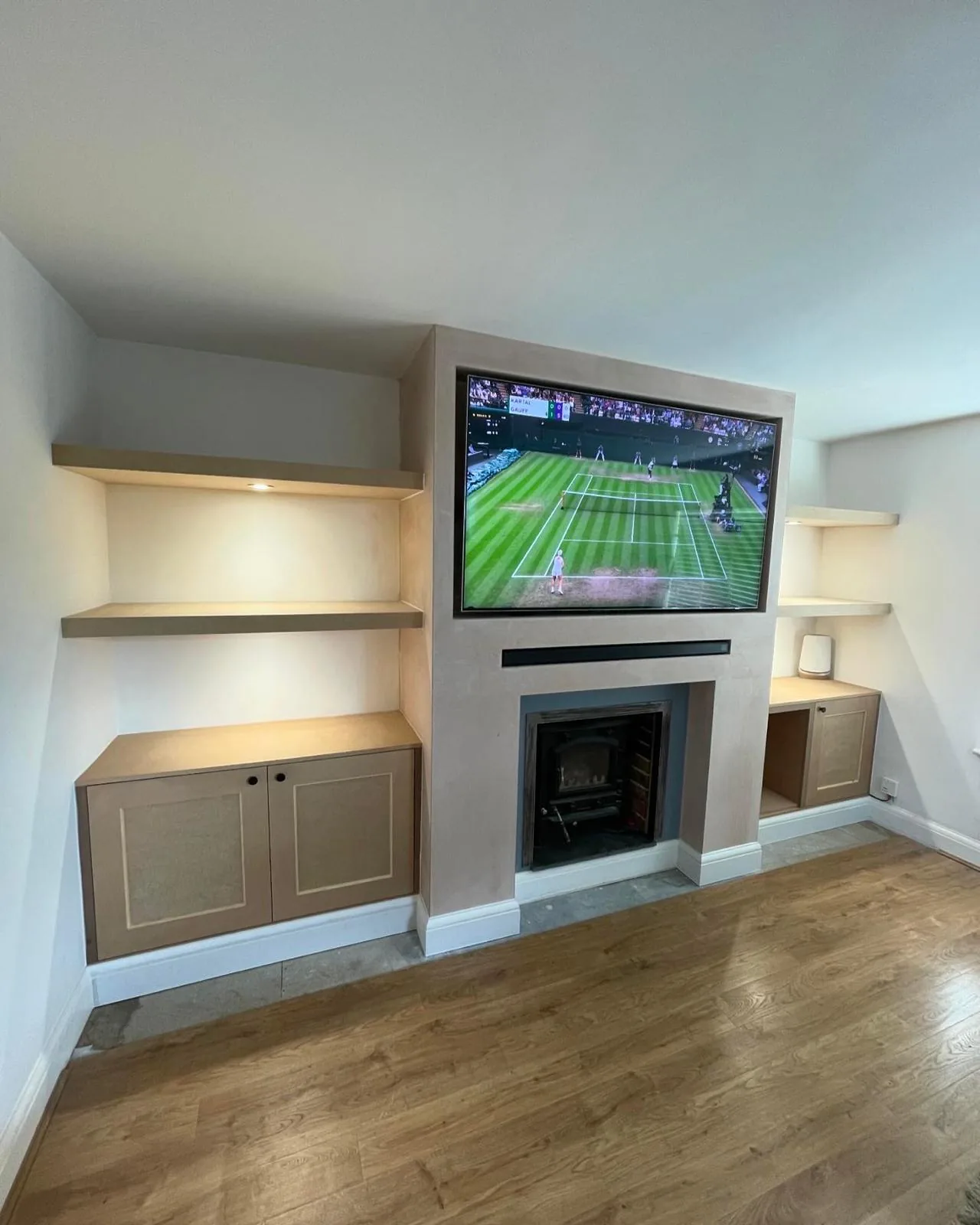 Completed media wall with shelving by RT Carpentry
